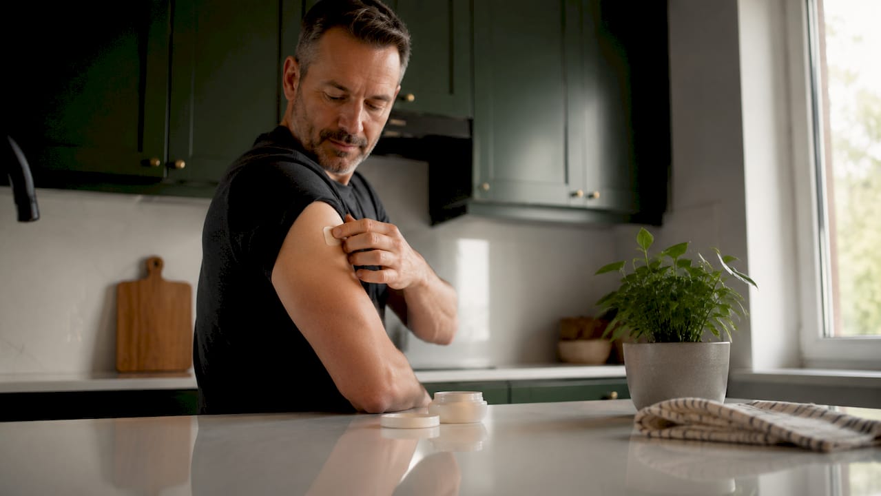 Man applying nicotine patch in bathroom