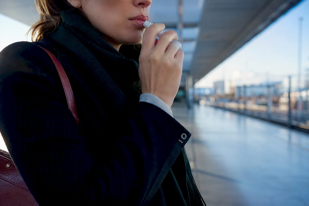 Woman using an anonymous oral mister